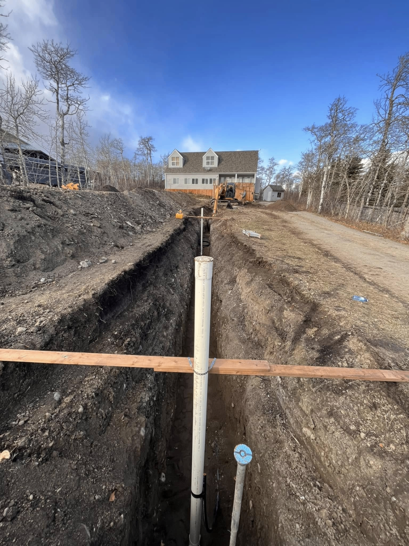 Trench with PVC service line ready for backfill